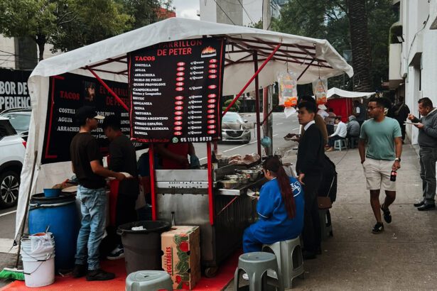 An outdoor food stand on a sidewalk that serves some of the best tacos in Mexico City
