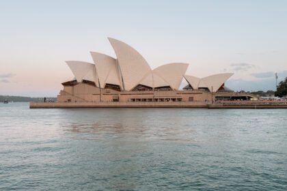 A white and brown architecturally interesting building on the water as part of the 10 things to do in Australia