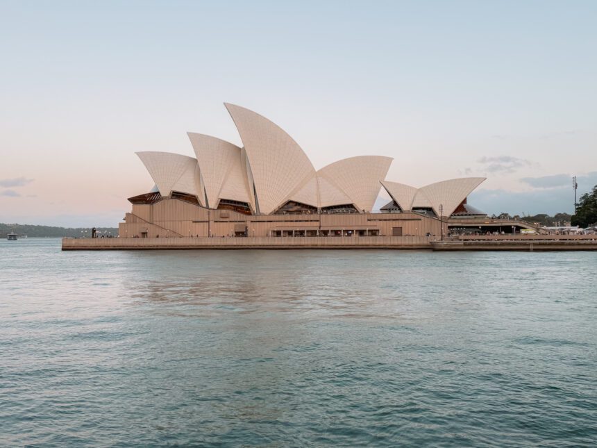A white and brown architecturally interesting building on the water as part of the 10 things to do in Australia