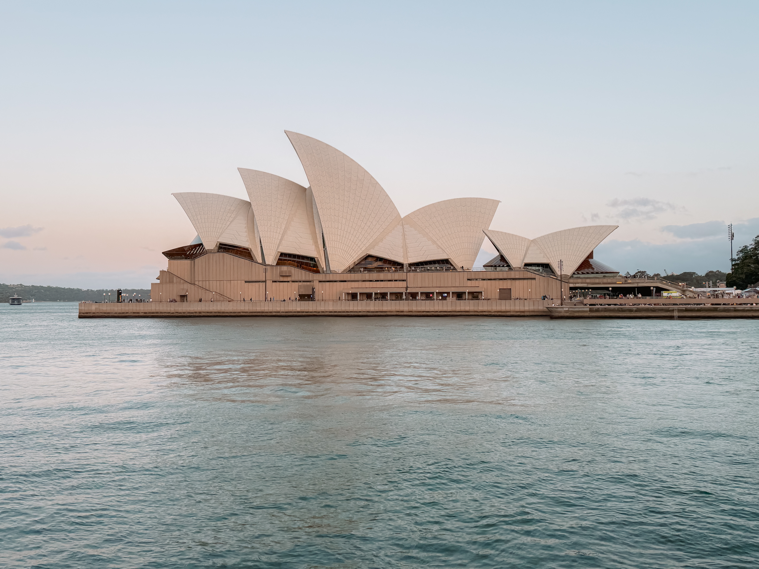 A white and brown architecturally interesting building on the water as part of the 10 things to do in Australia