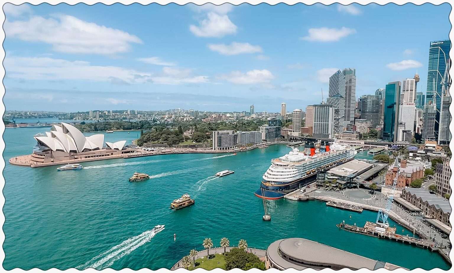 A view of the harbor of Sydney, Australia from the Sydney Harbor Bridge with boats going through the harbor