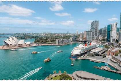 A view of the harbor of Sydney, Australia from the Sydney Harbor Bridge with boats going through the harbor
