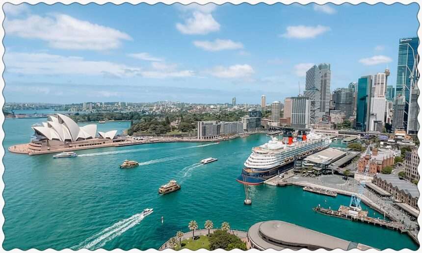 A view of the harbor of Sydney, Australia from the Sydney Harbor Bridge with boats going through the harbor