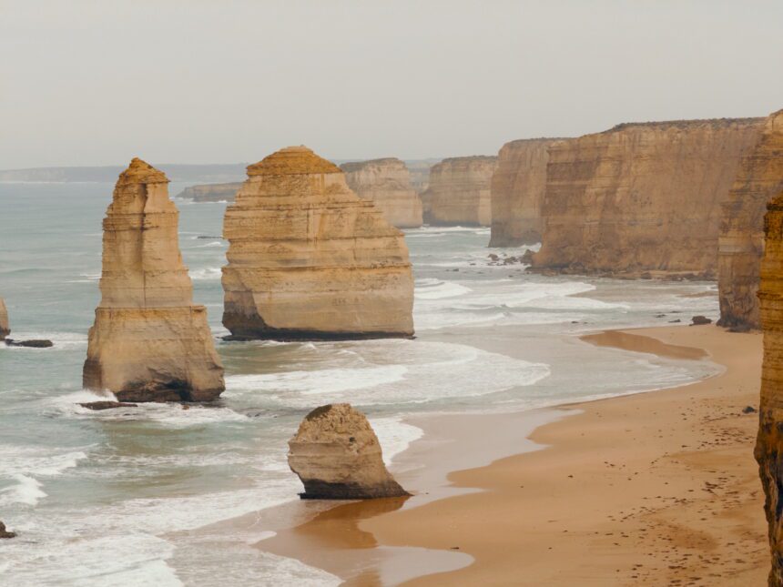 rock formations in an ocean along a cliff - best things to do on the Great Ocean Road