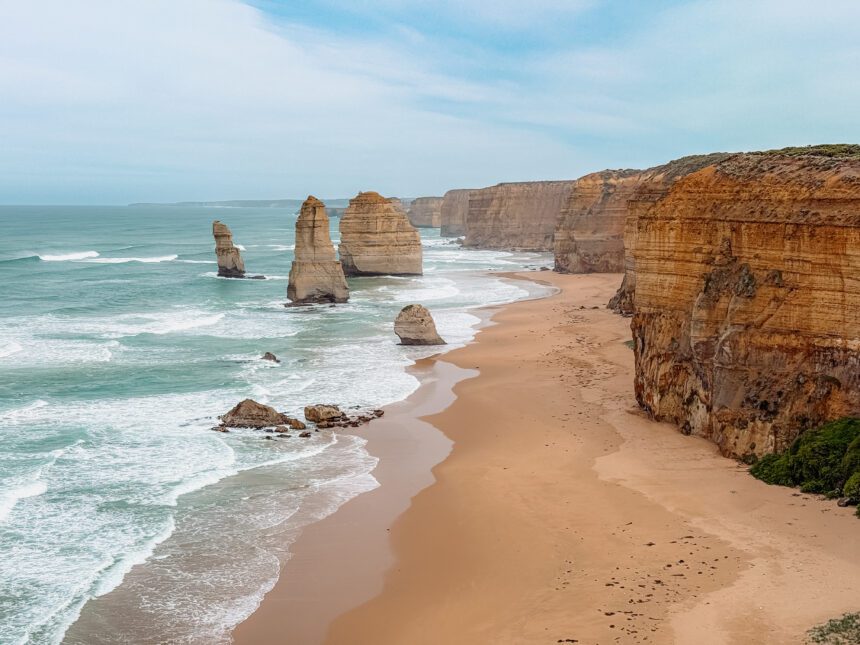 rock formations in an ocean along a cliff - Great Ocean Road Itinerary