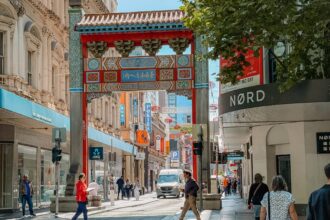 A Chinese gate over a city street, showing the local culture that answers is Melbourne worth visiting