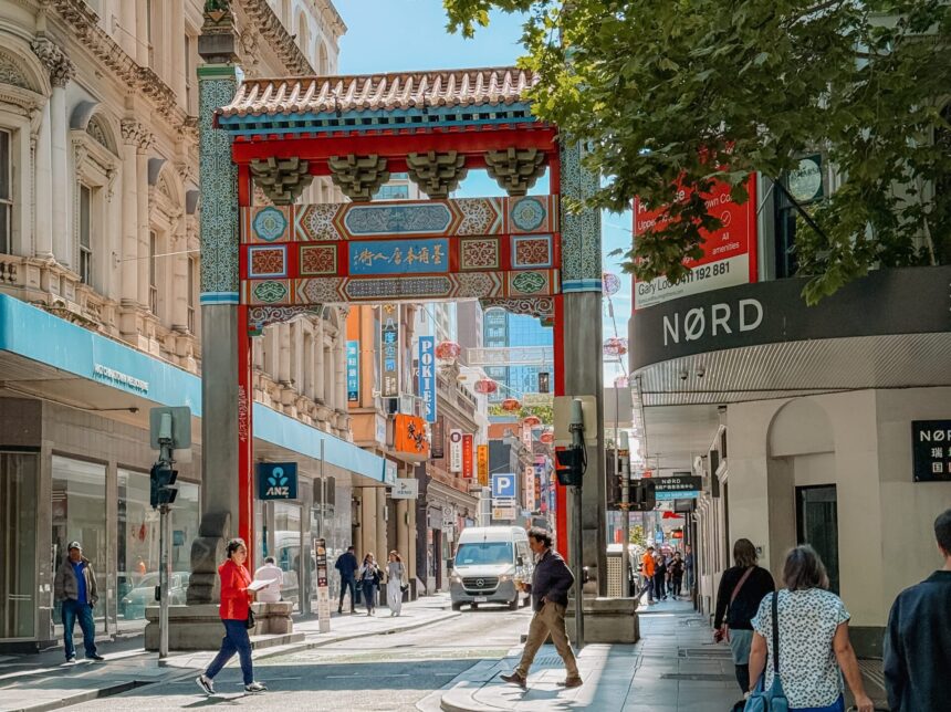 A Chinese gate over a city street, showing the local culture that answers is Melbourne worth visiting