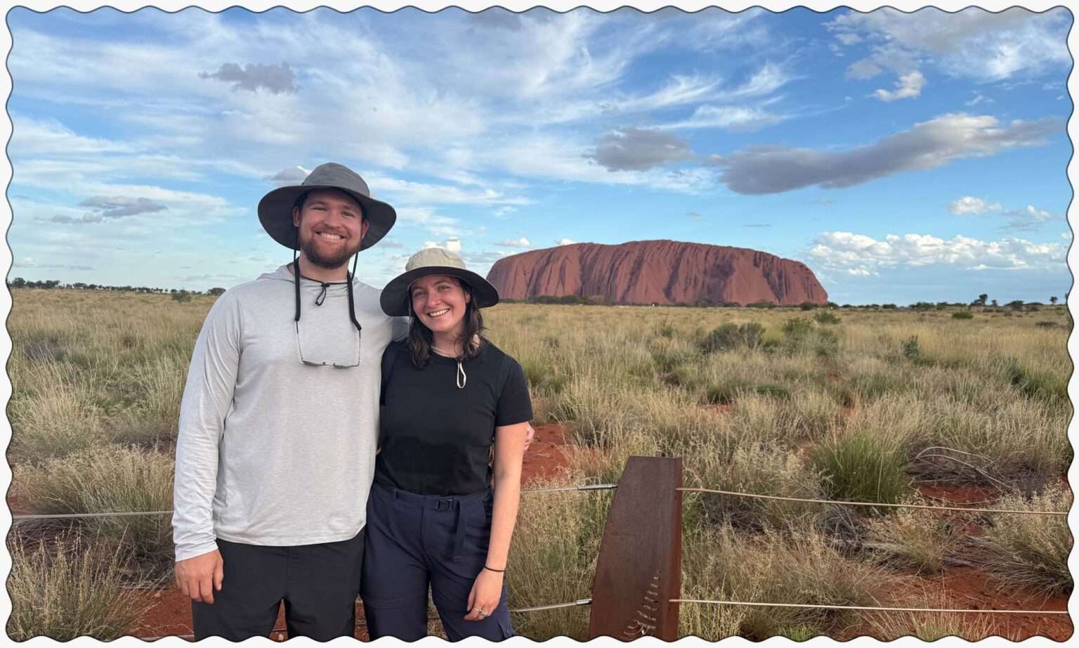 Standing in front of the rock of Uluru in the outback of Australia