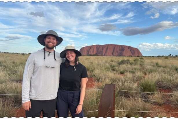 Standing in front of the rock of Uluru in the outback of Australia