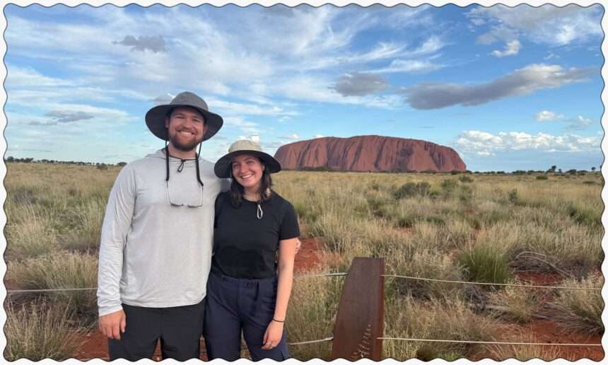 Standing in front of the rock of Uluru in the outback of Australia