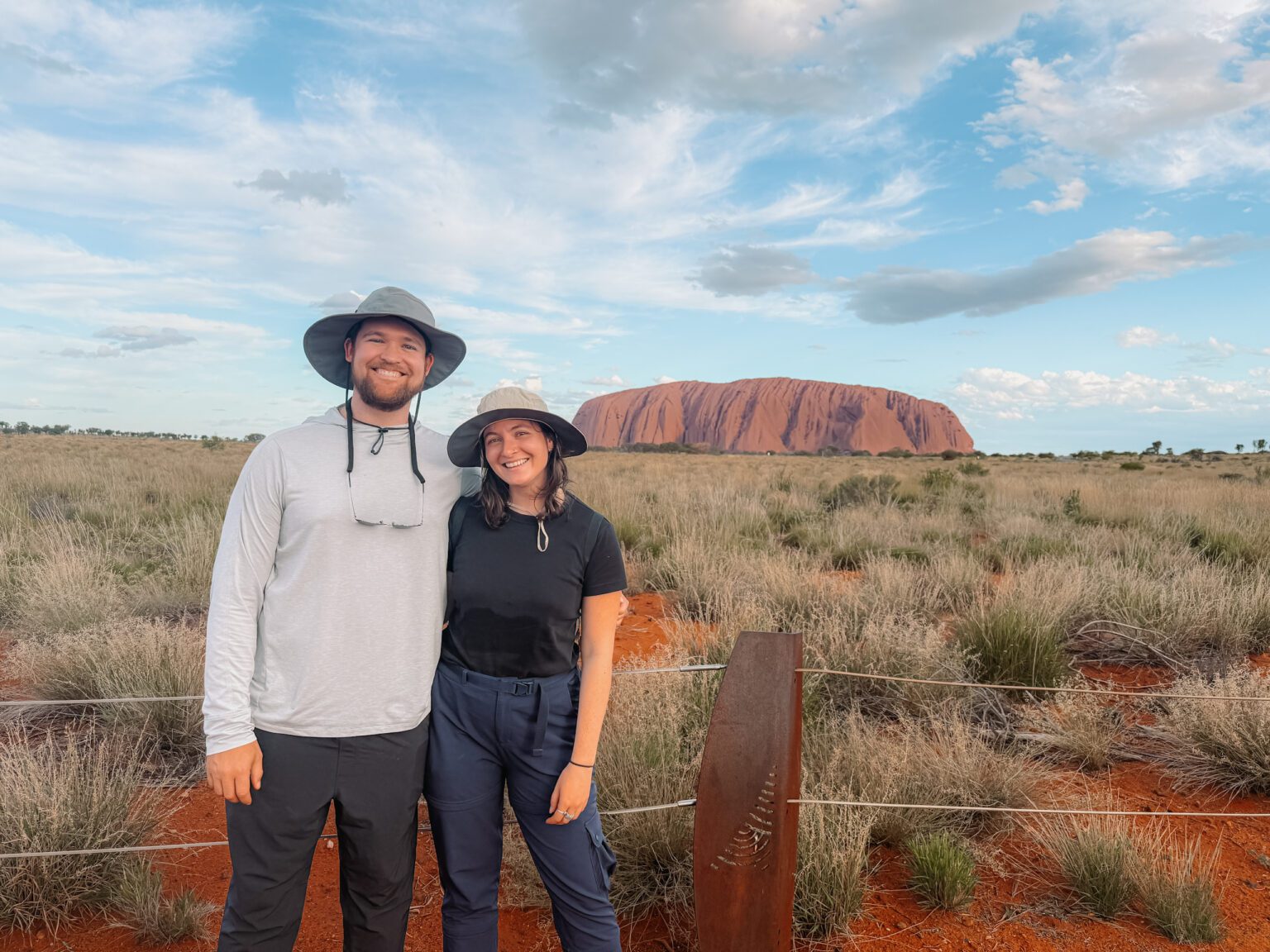Standing in front of the rock of Uluru in the outback of Australia