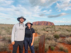 Standing in front of the rock of Uluru in the outback of Australia