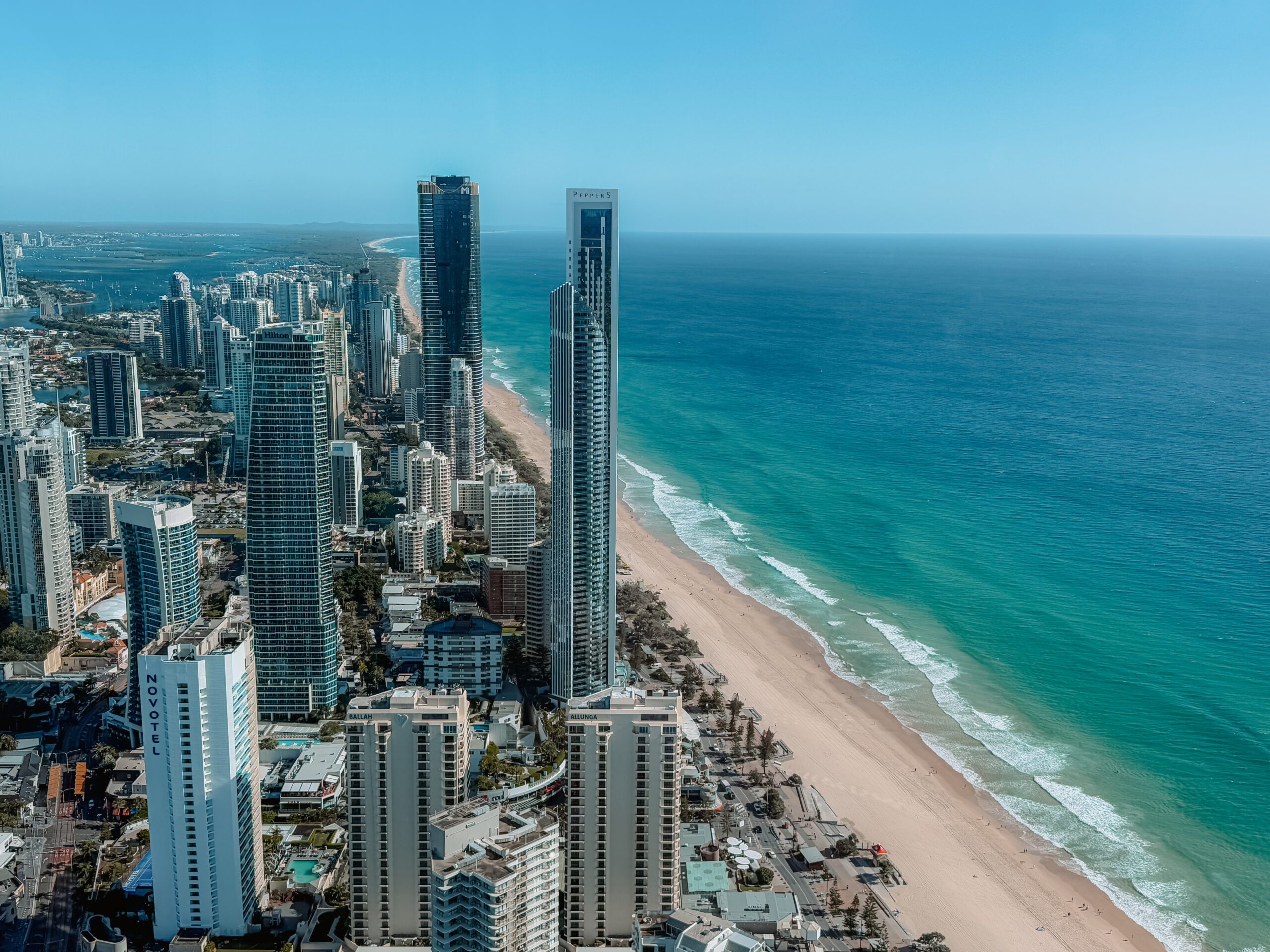 The view from a rooftop overlook of a city skyline along a beach coastline - Brisbane itinerary