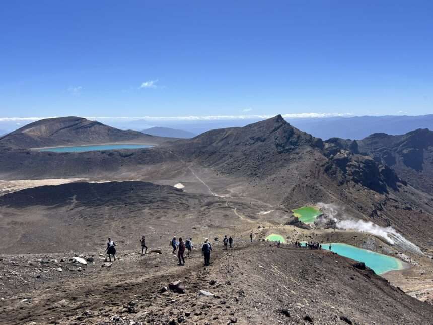 Turquoise pools nestled into the valley of a red rocky mountain outside of Taupo