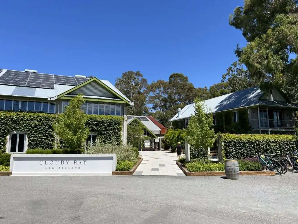 The entrance to a building with lots of greenery in front