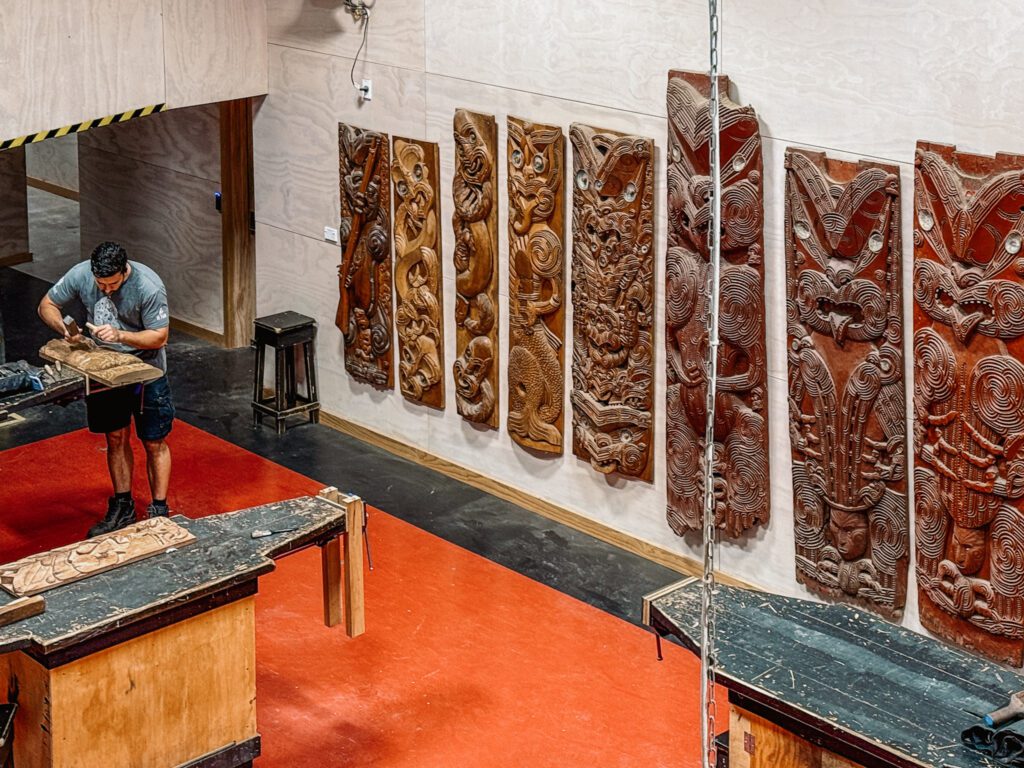 A wood carving studio with wood carvings completed on the wall at a studio in Rotorua