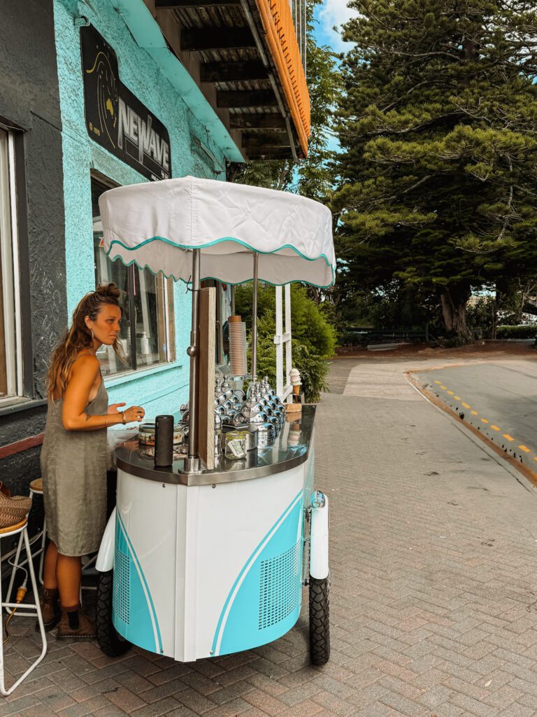 A teal and white ice cream stand in a beach town near Rotorua