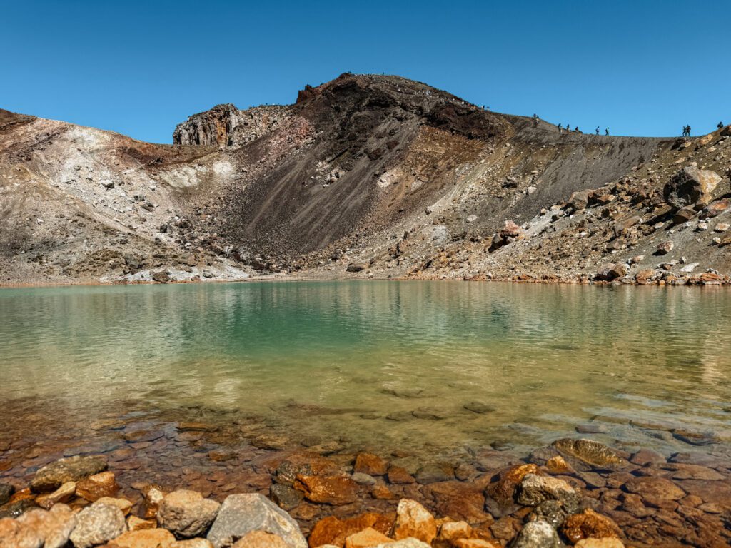 A rainbow lake in front of a mountain outside of Taupo