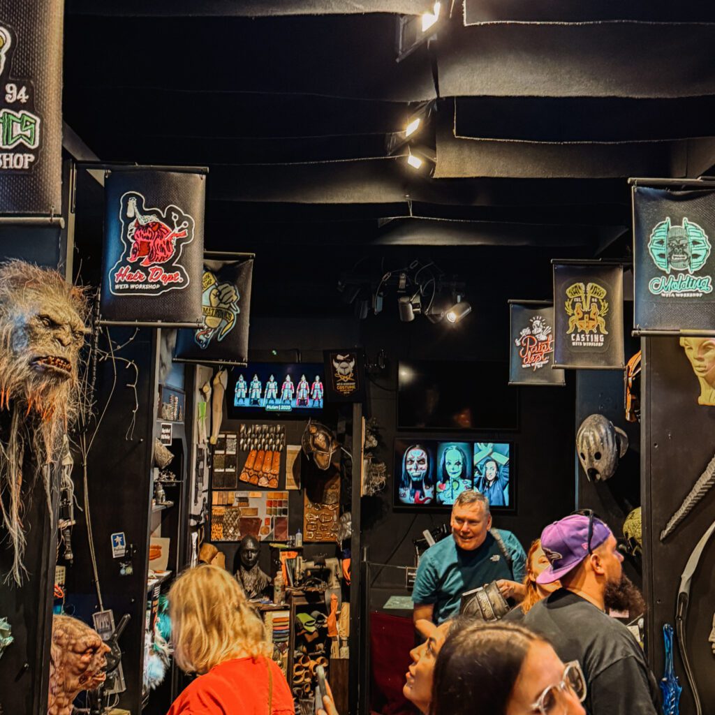 People crowded in a dark room with posters on the wall in Wellington