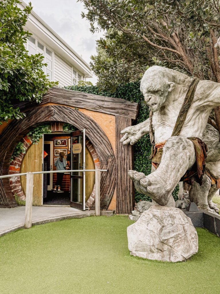 A troll standing at the entrance of a door at a building in Wellington