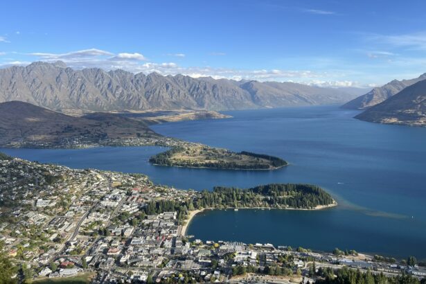 A town sitting on the edge of lake between mountains that can be visiting on your trip to Queenstown