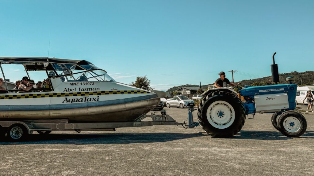 A tractor pulling a boat full of people in Abel Tasman National Park