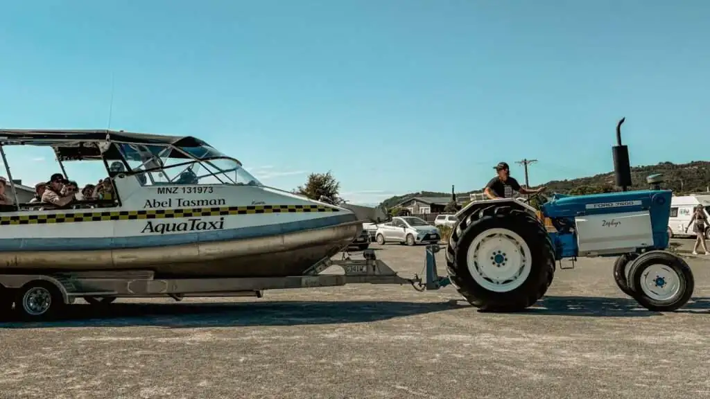 A tractor pulling a boat full of people - Things to do in Abel Tasman National Park
