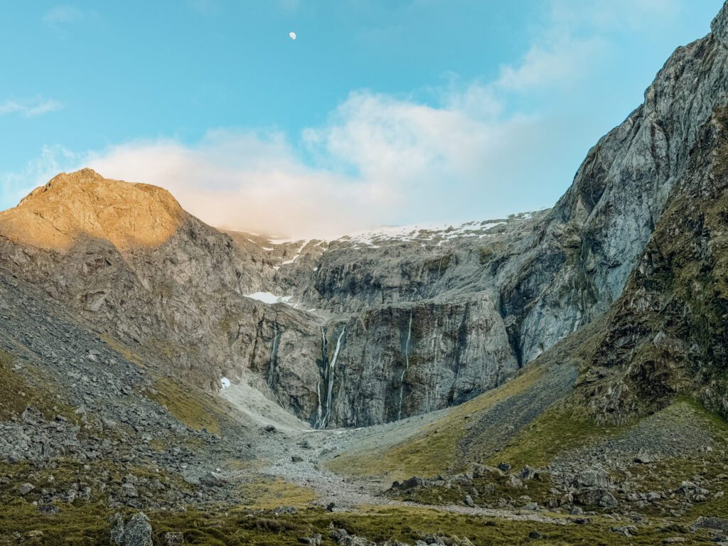 A mountain face with waterfalls coming off of it in Fiordland National Park