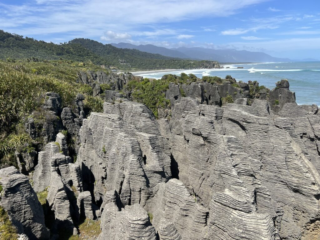 Rocks in a unique flat and stacked formation along the coast near the Southern Alps