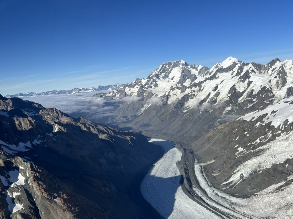A view of a glacier flowing between mountains of the Southern Alps