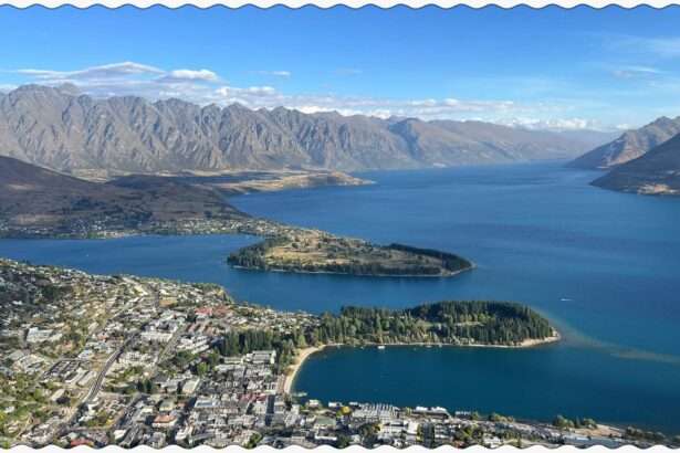 A town sitting on the edge of lake between mountains that can be visiting on your trip to Queenstown