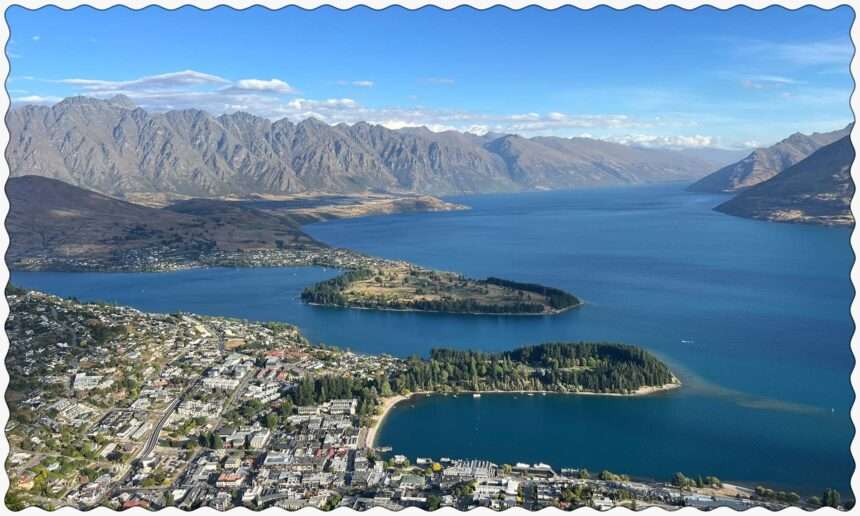 A town sitting on the edge of lake between mountains that can be visiting on your trip to Queenstown