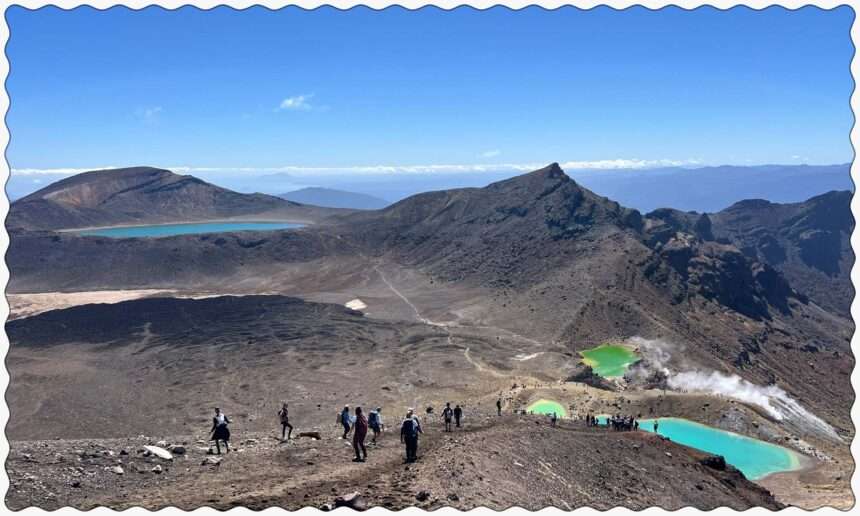 Turquoise pools nestled into the valley of a red rocky mountain outside of Taupo