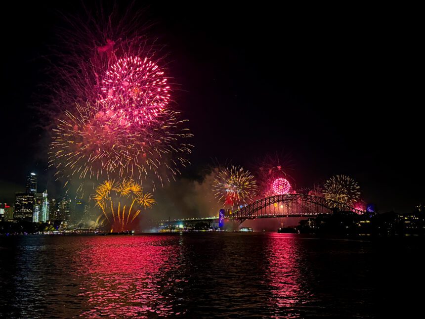 A pink firework show over the city skyline of Sydney - New Year's Eve in Sydney