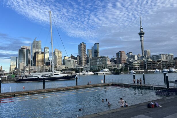 A pool in a harbor with a city in the background in Auckland, New Zealand