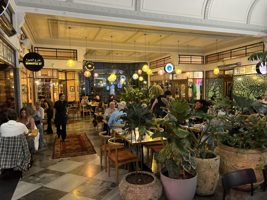 The interior of an arcade full of tables, chairs, and diners in Auckland, New Zealand