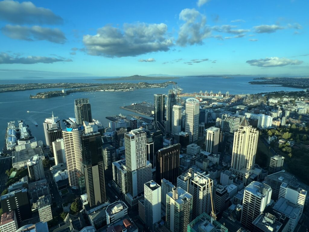 A view of skyscrapers in an oceanside city from above in Auckland, New Zealand