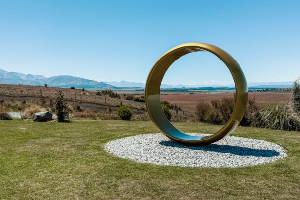 A large gold ring on a hill in front of a field used as one of the filming locations in the Lord of the Rings