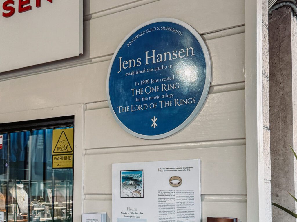 A building with a blue sign on it to indicate a manufacturer of the rings used as part of the filming locations in Lord of the Rings