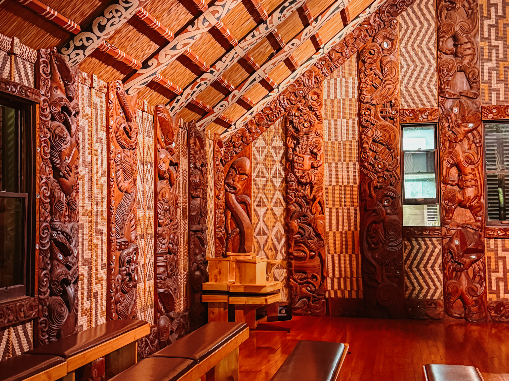 A room full of tapestry and red wooden carving on the North Island