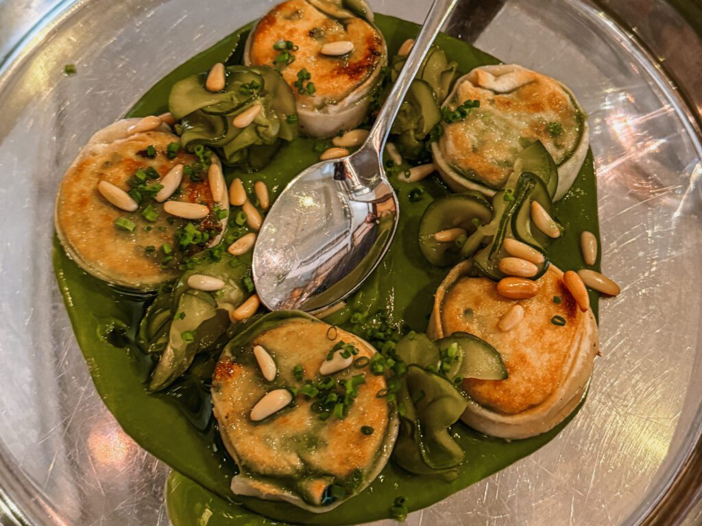 5 ravioli in a green sauce on a plate in Auckland