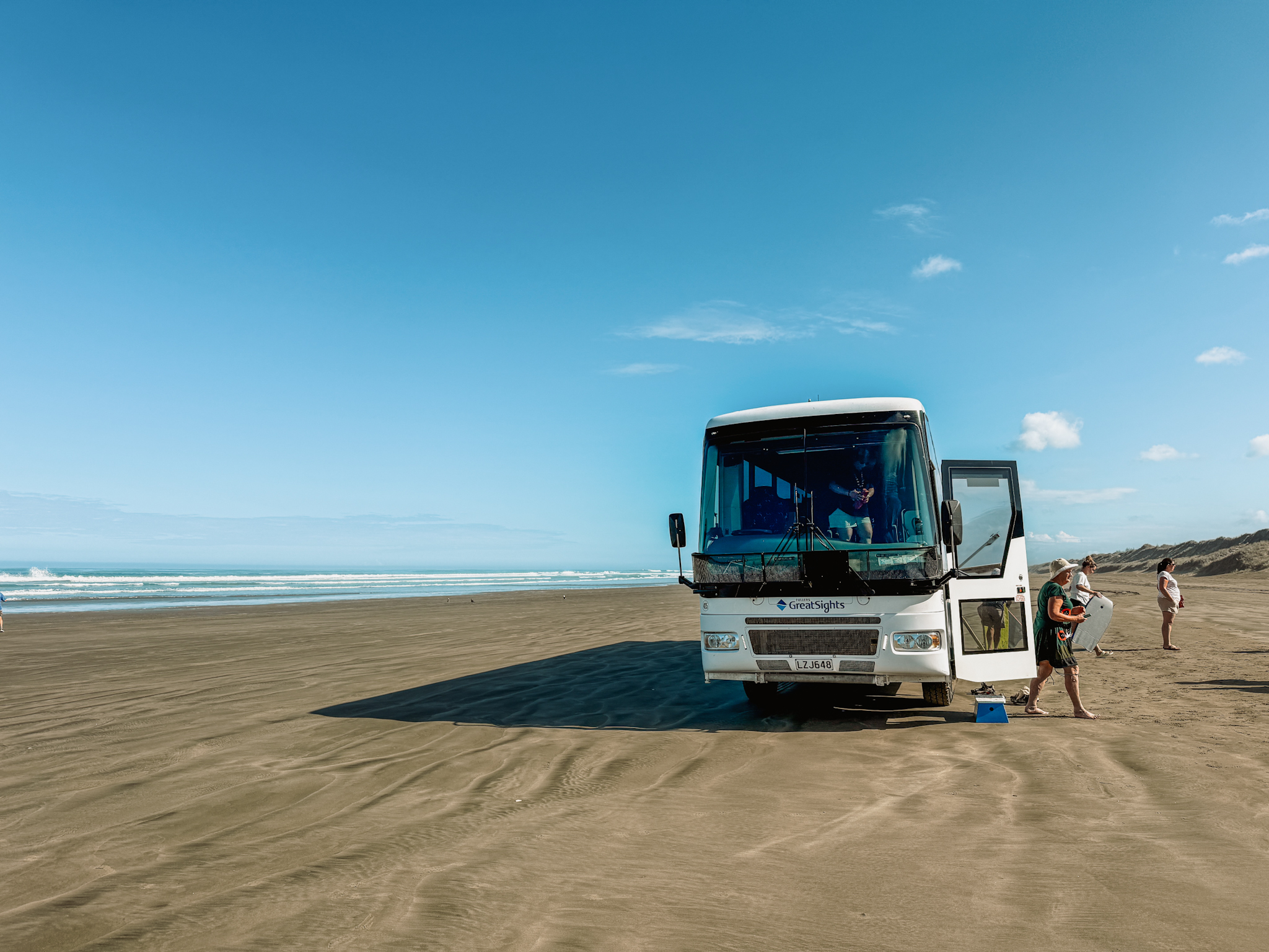 A bus on a beach and one of the things to do in northland