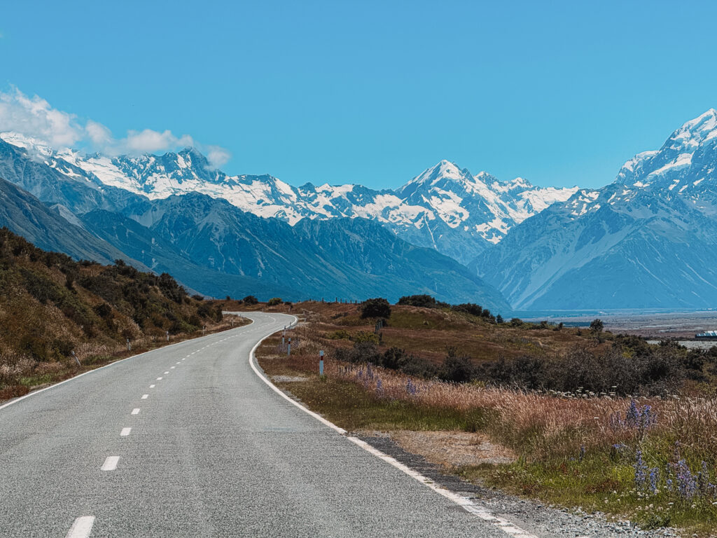 An enormous mountain looming over a road on one of the New Zealand Islands