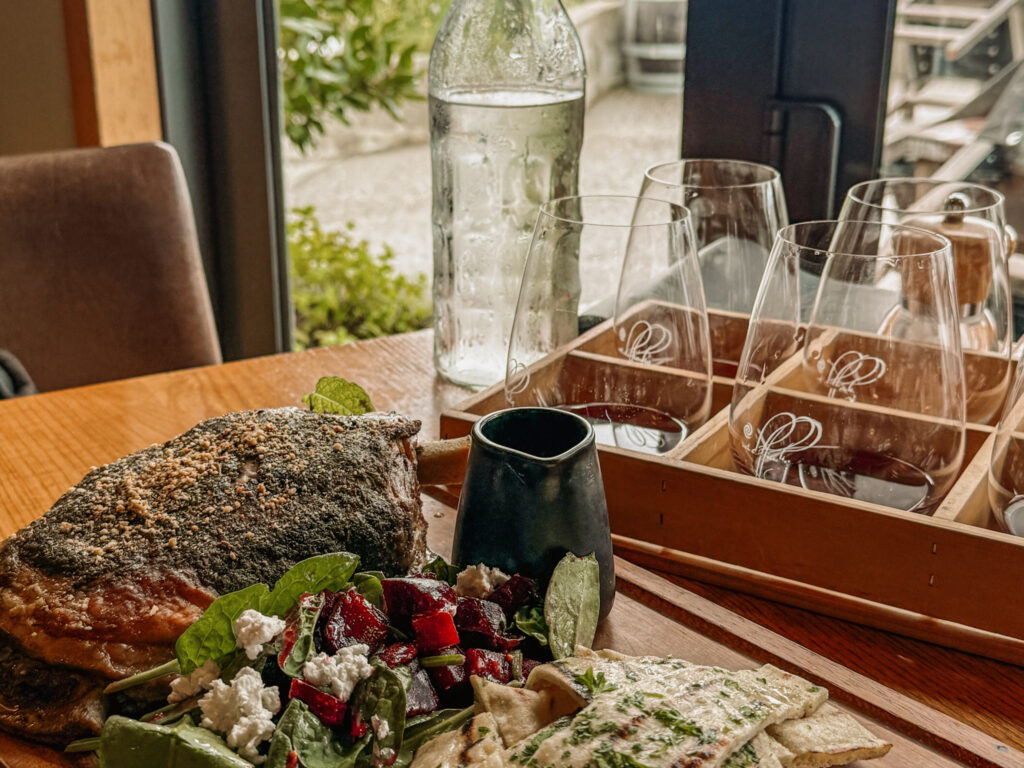 A plate of food and wine tasting at a restaurant in one of the wine regions of New Zealand