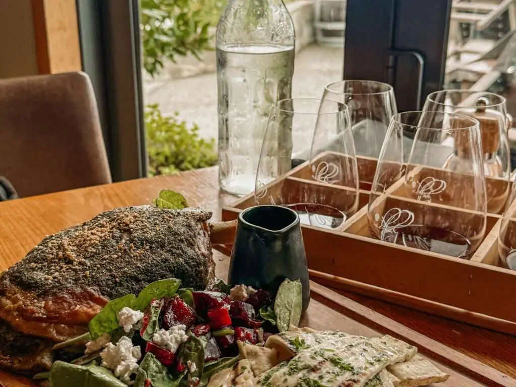 A plate of food and wine tasting at a restaurant in one of the wine regions in New Zealand