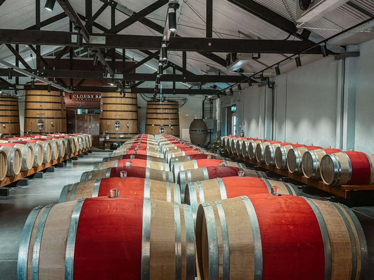 A room full of wooden barrels in one of the wine regions in New Zealand