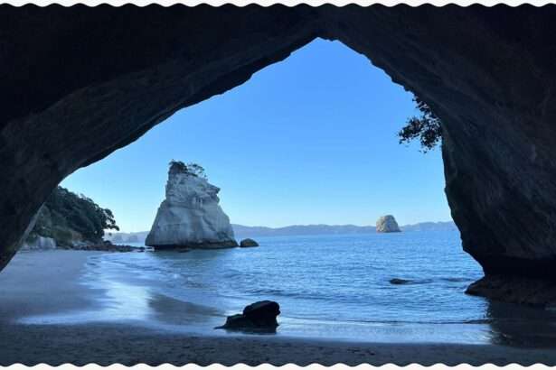 A view through a cave of a rock formation in the water of the Coromandel Peninsula
