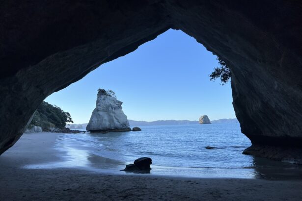 A view through a cave of a rock formation in the water of the Coromandel Peninsula