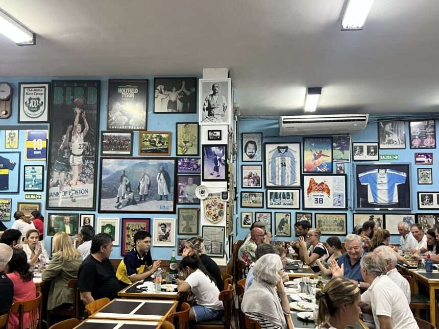 People sitting in a restaurant with walls covered in Argentina paraphernalia - Argentina dining recommendations