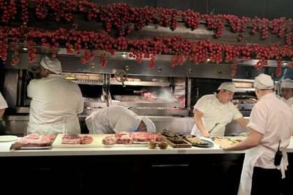 Chefs cooking behind a counter of a restaurant - Argentina food and drinks